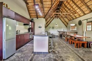 a large kitchen with a counter and a table at Luxury Kruger Escape in Marloth Park