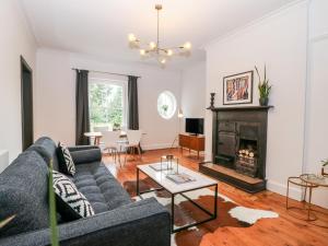 a living room with a couch and a fireplace at No 2 Pepper Arden in Northallerton