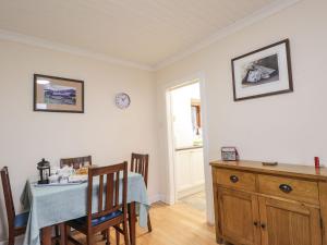 a dining room with a table and a window at Craigard in Balmacara