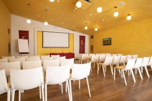 a room with white chairs and a projection screen at Best Western Ai Cavalieri Hotel in Palermo