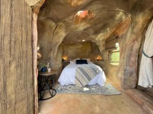 a bedroom in a cave with a bed in it at Zion Glamping Adventures in Hildale