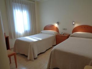 Postel nebo postele na pokoji v ubytování Hostal El Retiro