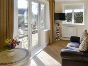 a living room with a couch and a table at High Trees Annex in Widdrington