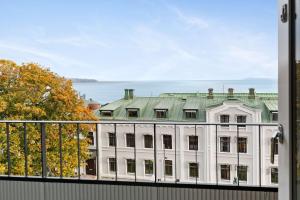 a large white building with a green roof at Sure Hotel by Best Western City Jonkoping in Jönköping