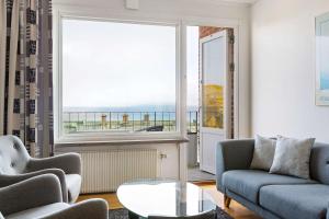 a living room with a couch and a table and a window at Sure Hotel by Best Western City Jonkoping in Jönköping