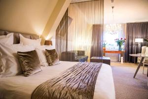 a bedroom with a large bed and a living room at Luxury Suites Amsterdam in Amsterdam