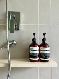 two bottles of soap sitting on a shelf in a bathroom at KL COSY CONDO - NEW Stylish home above KL East Mall in Kuala Lumpur