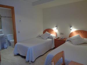 Postel nebo postele na pokoji v ubytování Hostal El Retiro