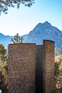 a brick wall with a door in front of a mountain at Zion Glamping Adventures in Hildale