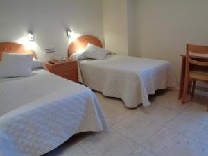 Postel nebo postele na pokoji v ubytování Hostal El Retiro