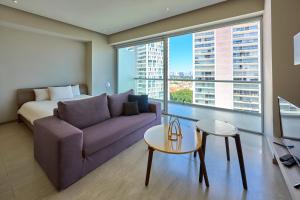 a living room with a couch and a bed and a window at Park Life Guadalajara in Guadalajara