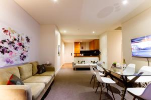 a living room with a couch and a table at Melbourne Royal Botanical Gardens 2BR in Melbourne