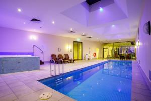 a large swimming pool in a large room with at Melbourne Royal Botanical Gardens 2BR in Melbourne