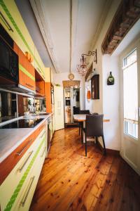 a kitchen with a wooden floor and a table at DUOMO - The Warm Maison - EXCLUSIVE in Milan +10 photos