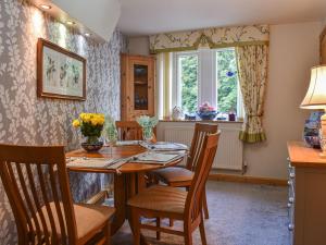 a dining room with a table and chairs and a window at The Haven in Heysham