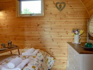 a bedroom with a bed in a wooden wall at Park View - Ukc4925 in Roydon