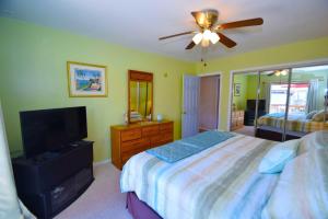 a bedroom with a bed and a flat screen tv at Club Ocean Villas II 19 condo in Ocean City