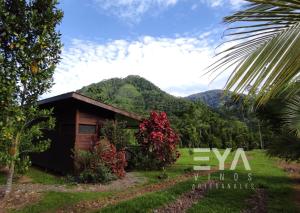 a house with a mountain in the background at EYA Ecolodge in San Isidro