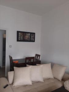 a living room with a couch and a picture on the wall at Cozy place in the heart of rabat in Rabat