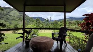 a porch with a table and a chair and a view at EYA Ecolodge in San Isidro