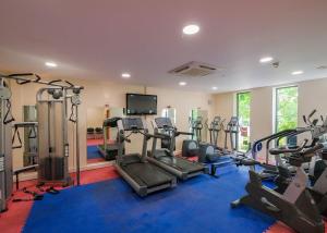 a gym with several treadmills and machines in a room at Fell End in Milnthorpe