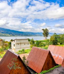 a view from the roof of a house with a lake in the background at Glamping Campo Lago San Pablo in Otavalo