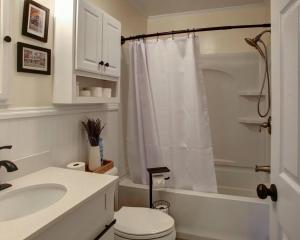 a bathroom with a toilet and a sink and a shower at Cape May Classic Design that is Cozy, Elegant, and Inviting in Cape May +16 photos