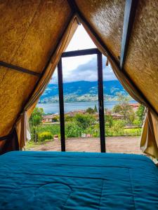a view from inside a tent looking out at the ocean at Glamping Campo Lago San Pablo in Otavalo