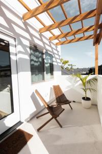 a pair of chairs sitting on a balcony at The Laurel Loft in San Diego