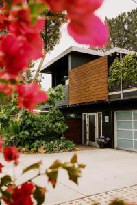 a house with red flowers in front of it at Twelve Senses Retreat, a Member of Design Hotels in Encinitas