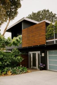 a house with a wooden facade with a garage at Twelve Senses Retreat, a Member of Design Hotels in Encinitas