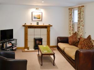 a living room with a couch and a fireplace at Midday in Silloth