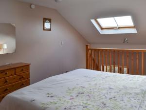 a bedroom with a bed and a skylight at Lakeland View in Scotforth