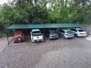a group of cars parked in a parking lot at Chalets de la paix in Santa Rosa de Calamuchita