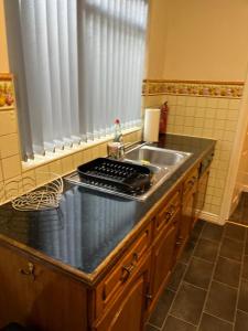 a kitchen with a sink and a counter top at HILLTOP PLACE SUITES M1 J31 near PEAK DISTRICT 