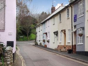 an empty street in a village with white houses at Blackberry Cottage in Kenton