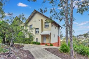 a house with a pathway leading to it at Villa 3br Syrah Villa located within Cypress Lakes Resort in Pokolbin