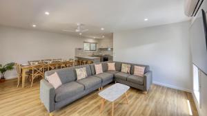a living room with a couch and a dining room at Tasman Holiday Parks - Moama on the Murray in Moama