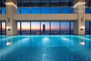 a swimming pool in a building with a view at Crowne Plaza Shenzhen Nanshan, an IHG Hotel in Shenzhen