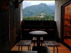 a table in a room with a view of a mountain at MOUNTAinn Nagiso in Nagiso