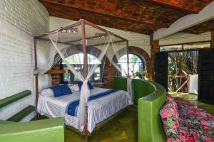 a bedroom with a canopy bed in a room at Sayulita Beach House Hotel in Sayulita