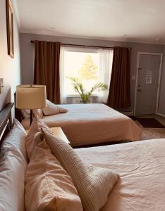 a bedroom with two beds and a window at Ledge Rock at Whiteface in Wilmington