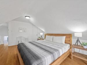 a white bedroom with a large bed and a table at Bloomfield/Shadyside @K Spacious & Unique Private Bedroom with Shared Bathroom in Pittsburgh