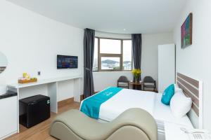 a hotel room with a bed and a desk at BOBO Boutique Hotel in Vung Tau