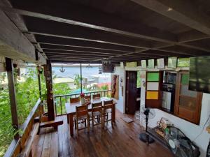 a room with a table and chairs on a balcony at Tanaw sa Anilao Beach Resort in Mabini