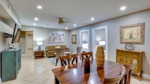 a living room with a wooden table and chairs at 4 Bedroom Beauty Steps from the River in Savannah