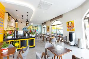 a restaurant with tables and chairs and a cafeteria at BOBO Boutique Hotel in Vung Tau