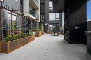 an internal courtyard of a building with plants at And Apartments in Canberra