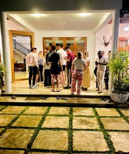 a group of people standing outside of a building at Mansala Safari House in Udawalawe