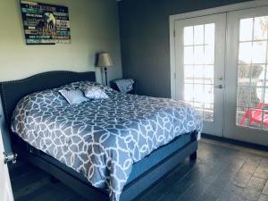 a bedroom with a bed with a blue and white comforter at Red Roof Stable and Farm LLC in Princeton